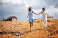 Two girls in dresses in autumn field Royalty Free Stock Photo