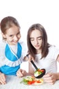 Two girls eating vegetarian salad