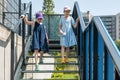 Two girls, elementary school age children walking down the stairs together, outdoors shot, two people, sisters, siblings or close Royalty Free Stock Photo