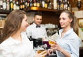 Two girls flirting with barman