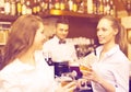 Two girls flirting with barman Royalty Free Stock Photo