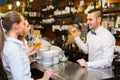 Two girls flirting with barman