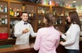 Two girls flirting with barman