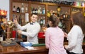 Two girls flirting with barman