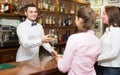 Two girls flirting with barman Royalty Free Stock Photo