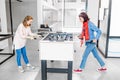 girls friends playing table football mini game indoors Royalty Free Stock Photo