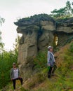 Two girls friends of tourists with a bottle of water in his hand are at the attractions of Yakutia sand mushrooms errosion Royalty Free Stock Photo