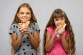 Two girls are funny eating bread