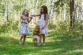 Two girls girlfriend walking in the woods with her beloved pet Spitz