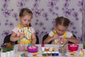 Two girls girlfriends getting ready for the Easter painted eggs