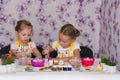 Two girls girlfriends getting ready for the Easter painted eggs