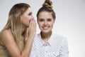 Two girls gossiping, one is satisfied Royalty Free Stock Photo