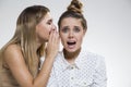 Two girls gossiping, one is terrified Royalty Free Stock Photo