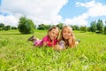 Two girls in the grass with butterfly Royalty Free Stock Photo