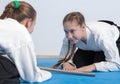 Two girls in hakama bow on Aikido training Royalty Free Stock Photo