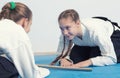 Two girls in hakama bow on Aikido training Royalty Free Stock Photo