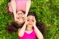 Two girls with hands round shape on face