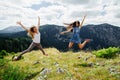 Two girls happy jump in mountains Royalty Free Stock Photo