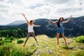 Two girls happy jump in mountains Royalty Free Stock Photo