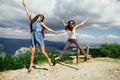 Two girls happy jump in mountains Royalty Free Stock Photo