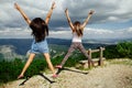 Two girls happy jump in mountains Royalty Free Stock Photo