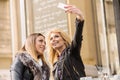 Two girls having fun while drinking coffee Royalty Free Stock Photo