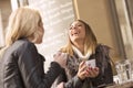 Two girls having fun while drinking coffee Royalty Free Stock Photo