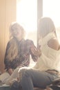 Two girls having fun while drinking coffee Royalty Free Stock Photo