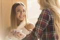 Two girls having fun while drinking coffee Royalty Free Stock Photo