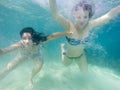 Two girls having fun swimming underwater Royalty Free Stock Photo