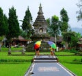 Two girls holding colorful unbrellas in Ulan Danu Beratan Temple, Bali, Indonesia