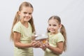 Two girls holding hands in an aquarium with goldfish Royalty Free Stock Photo