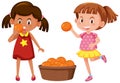 Two girls holding oranges Royalty Free Stock Photo