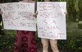 Two girls holding signs at immigration protest - We wont let history repeat itself - abolish ice - asylum - cropped and selective