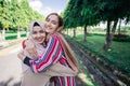 Two girls hug on the sidewalk. Feel joyfull and happy together.