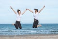 Two girls jumping on the beach Royalty Free Stock Photo