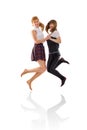 Two girls jumping and holding hands Royalty Free Stock Photo