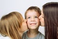 Two girls kissing little cheerful boy Royalty Free Stock Photo