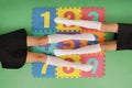 Two girls in knee-length socks on rug with numbers Royalty Free Stock Photo