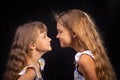 Two girls look at each other face to face