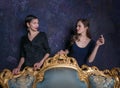 Two girls look at each other. Haughty eyes. A scene from the film. Girls from high society. Shooting in studio. Stage image. Inter