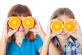 Two girls are looking through oranges Royalty Free Stock Photo