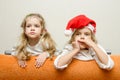 Two girls looking to left leaning back on the couch