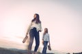 Two girls from a lower angle with shoes in their hands