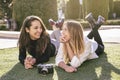 Two girls lying in a park having a fun conversation Royalty Free Stock Photo