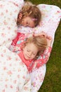 Two Girls Lying Under Blanket On Camping Holiday Royalty Free Stock Photo
