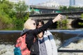 Two girls make a selphi near a river