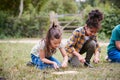 Two Girls On Outdoor Camping Trip Learning How To Make Fire Royalty Free Stock Photo