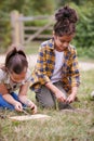 Two Girls On Outdoor Camping Trip Learning How To Make Fire Royalty Free Stock Photo