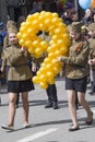 Two girls at the parade with balloons in form of digit nine (the date May 9 is Victory Day in World War II). Pyatigorsk, Russia